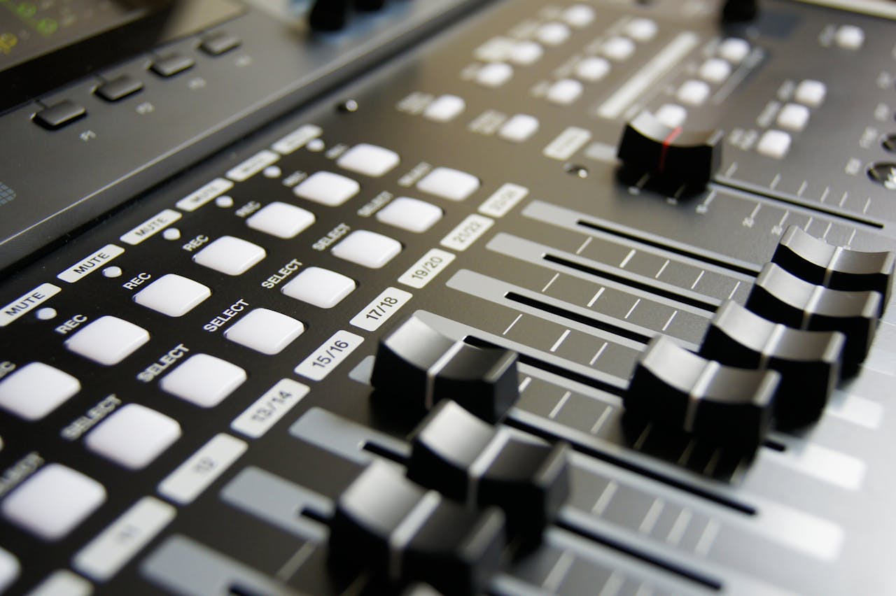 about-us Detailed view of audio mixer sliders and buttons for sound engineering and music production.