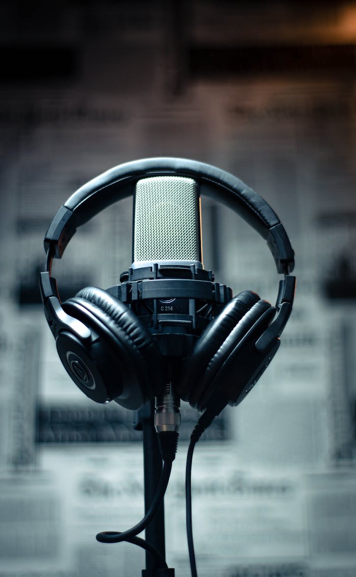 services-02 Microphone with headphones in a studio environment, perfect for sound recording and podcasting.
