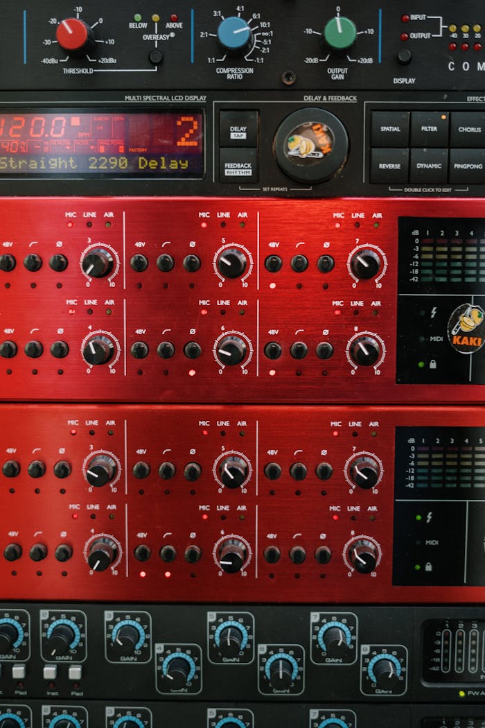 services-04 A detailed view of professional audio equipment in a music studio focusing on control panels and dials.